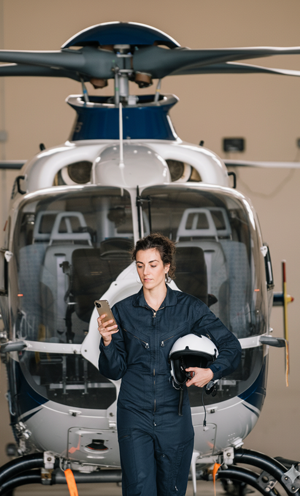 Pilot with helicopter in hangar